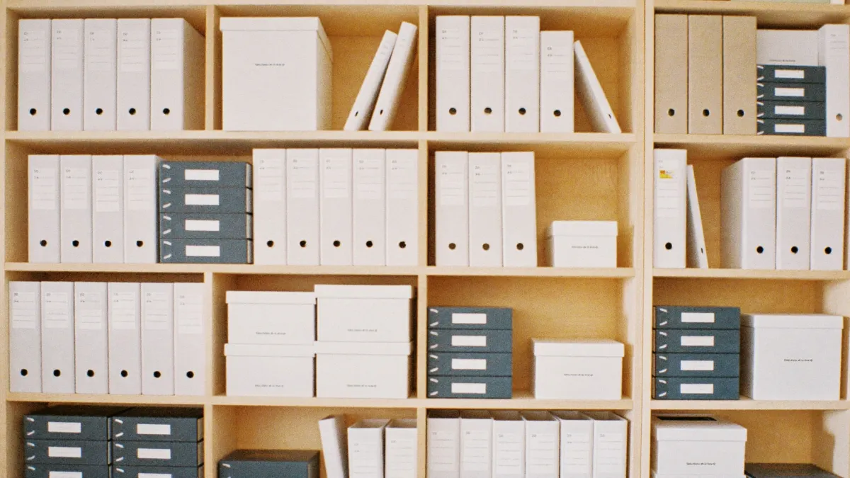 Neat archive boxes and binders on office shelving