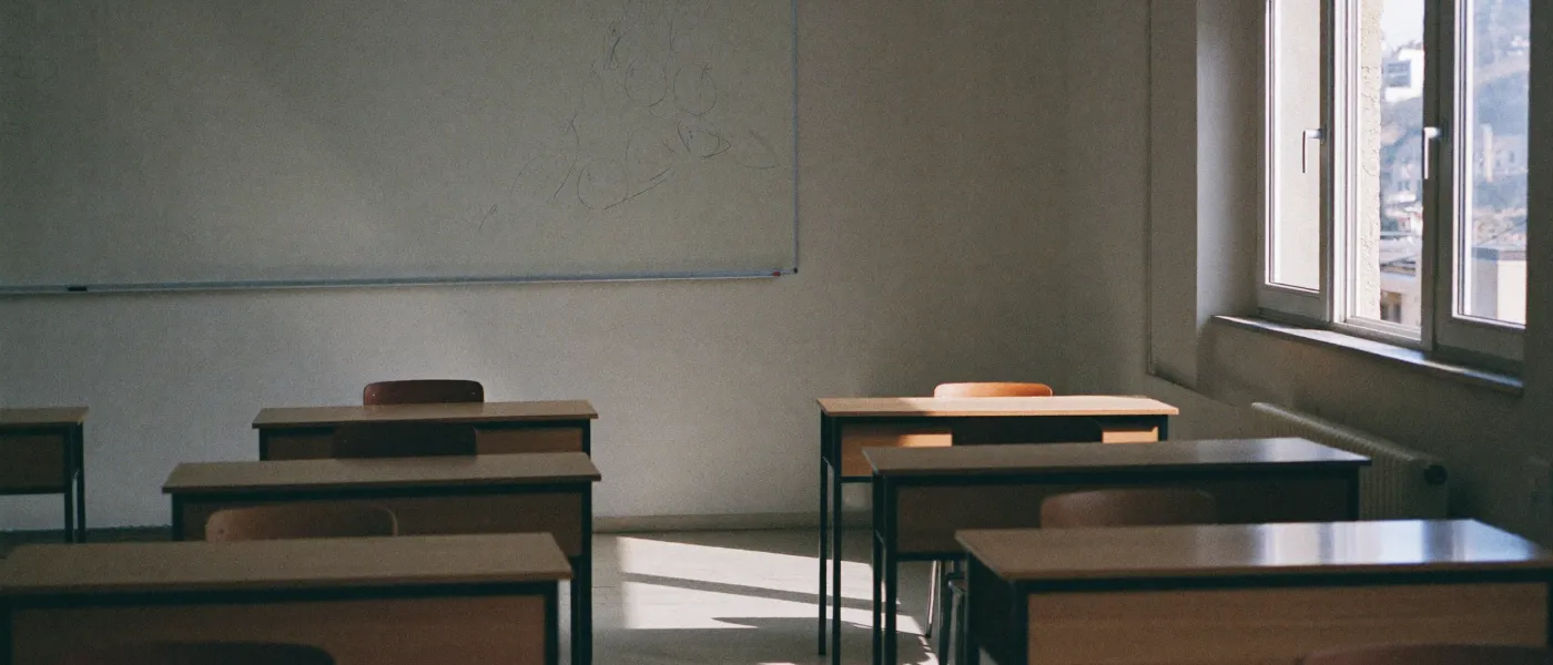 An empty tutoring centre classroom in Cyprus with desks and afternoon light